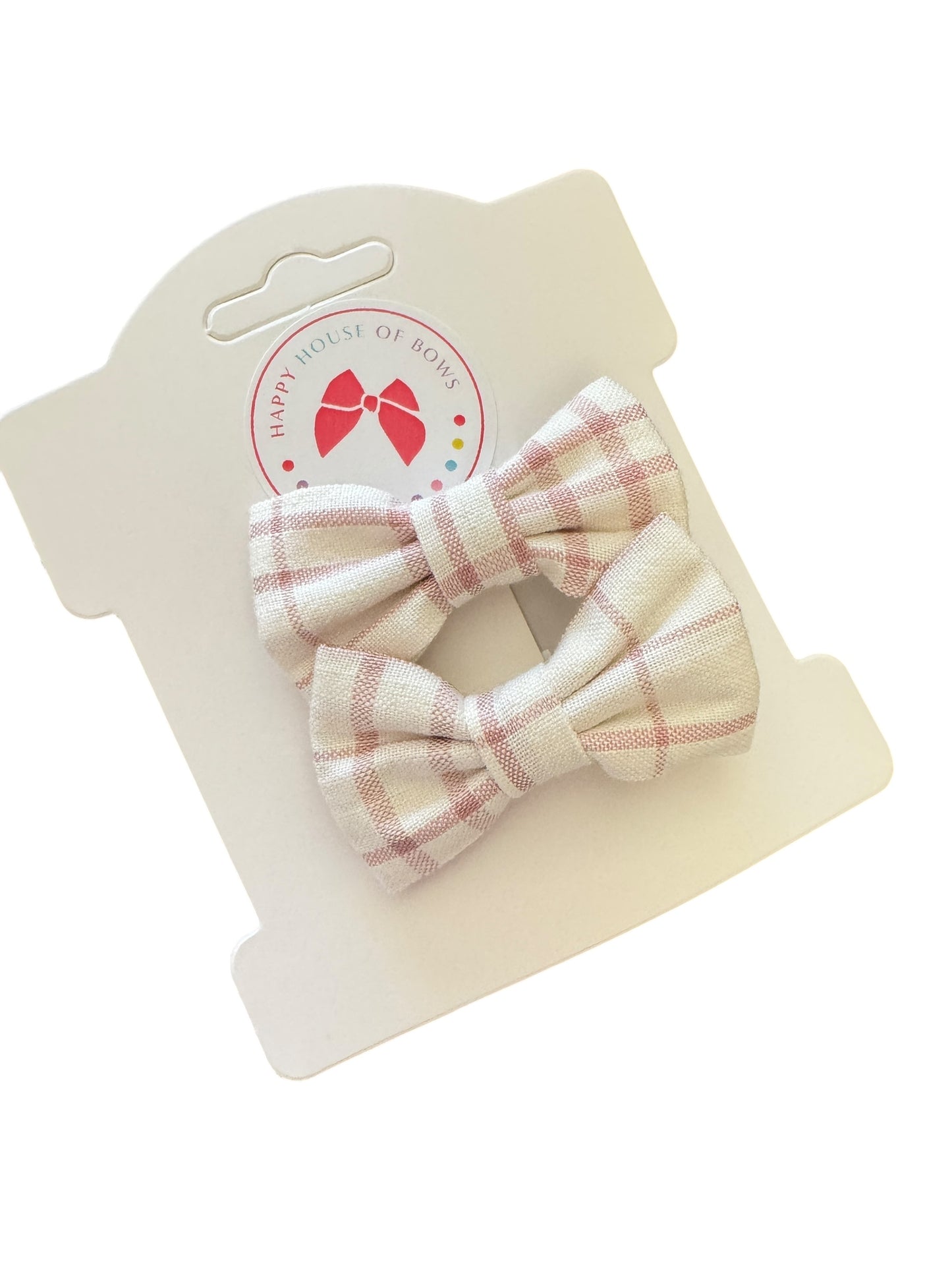 Two plaid hair bows on a branded card with a white background