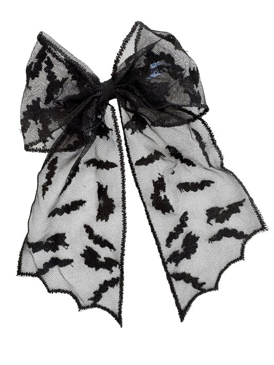 Black hair bow with bat pattern on a white background