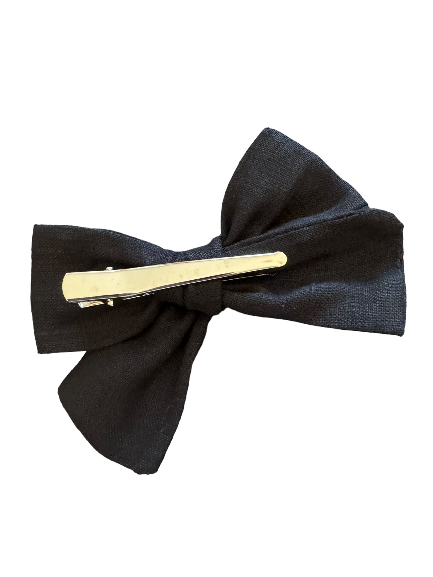 A black hair bow with a glowing blue ghost design, attached to an alligator clip, against a white background. with a clip attached