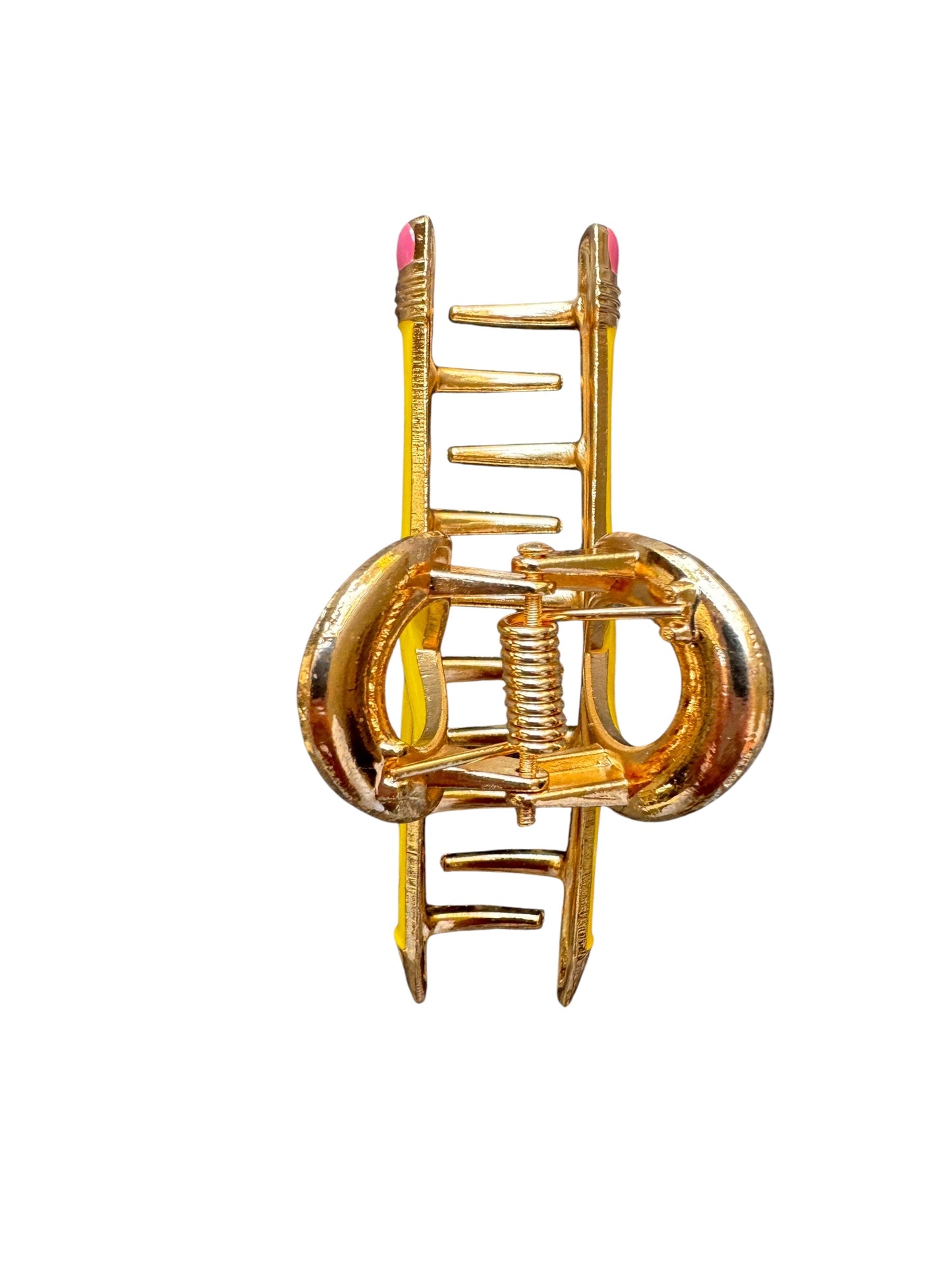 Yellow pencil claw clip with a unique design held by a hand on a white background