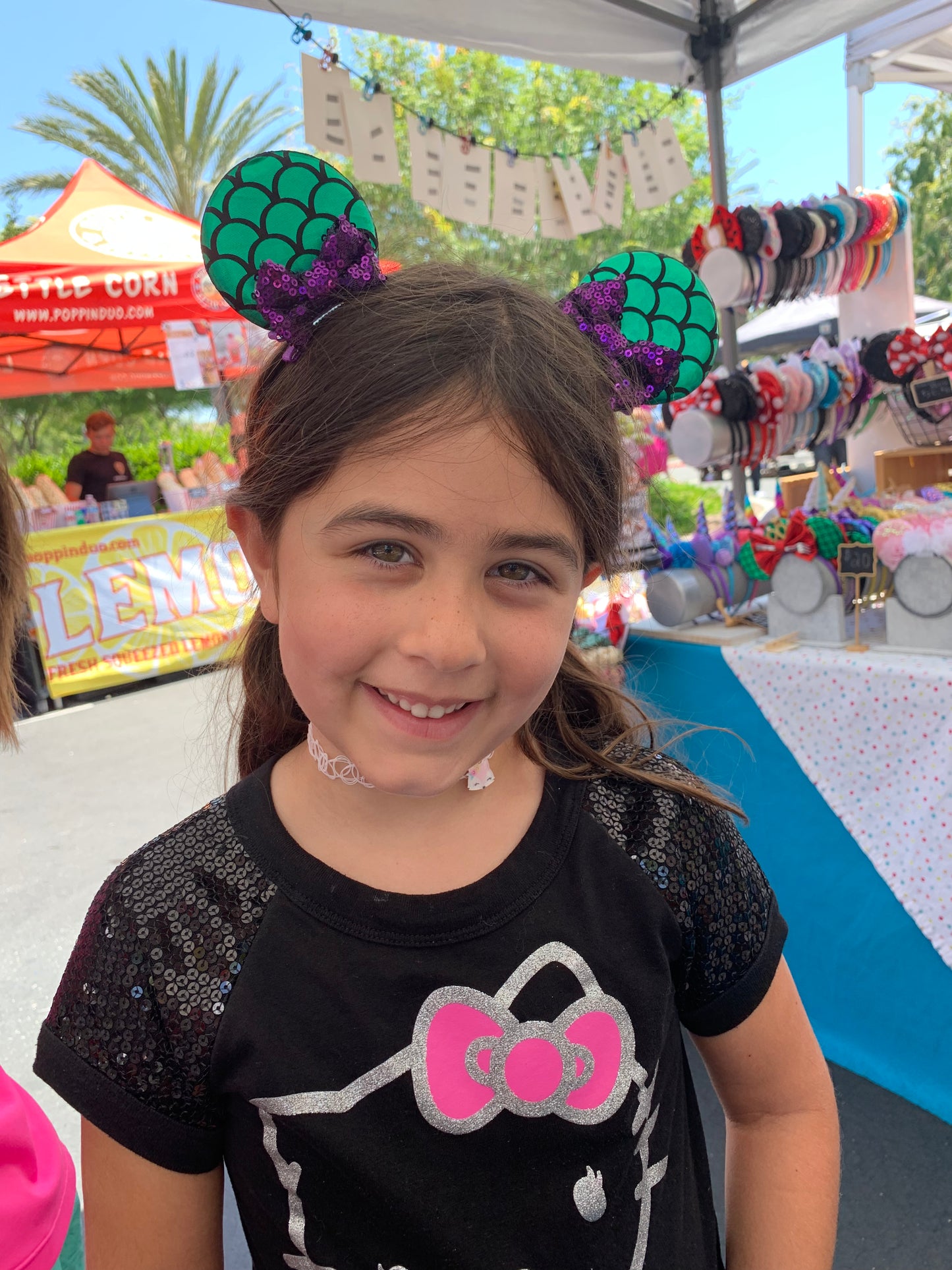 girl wearing a set of mermaid mouse ear clips