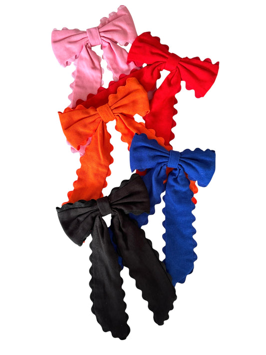 Set of colorful ruffled hair bows on a white background