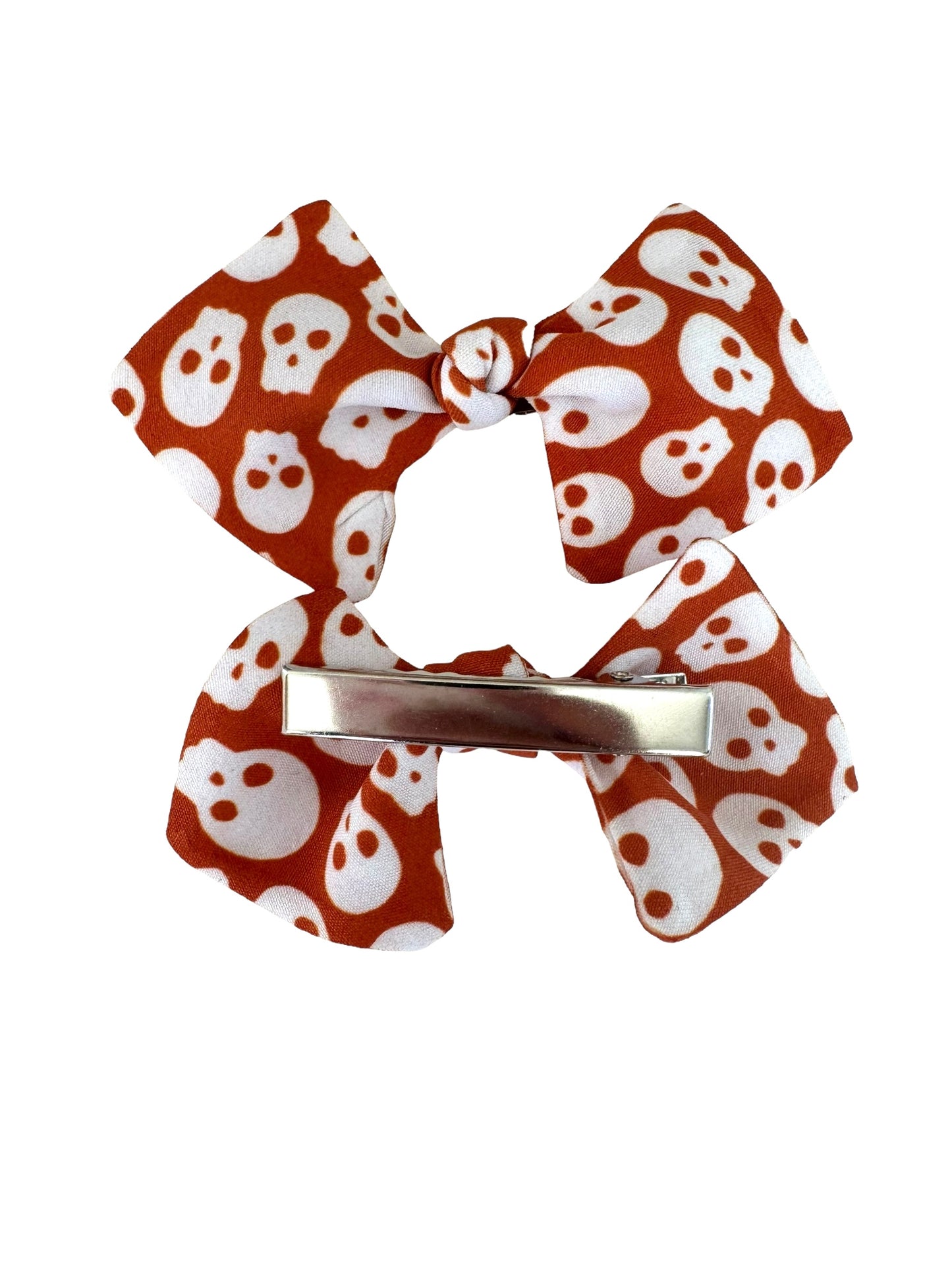 orange skull mini bows on an alligator clip