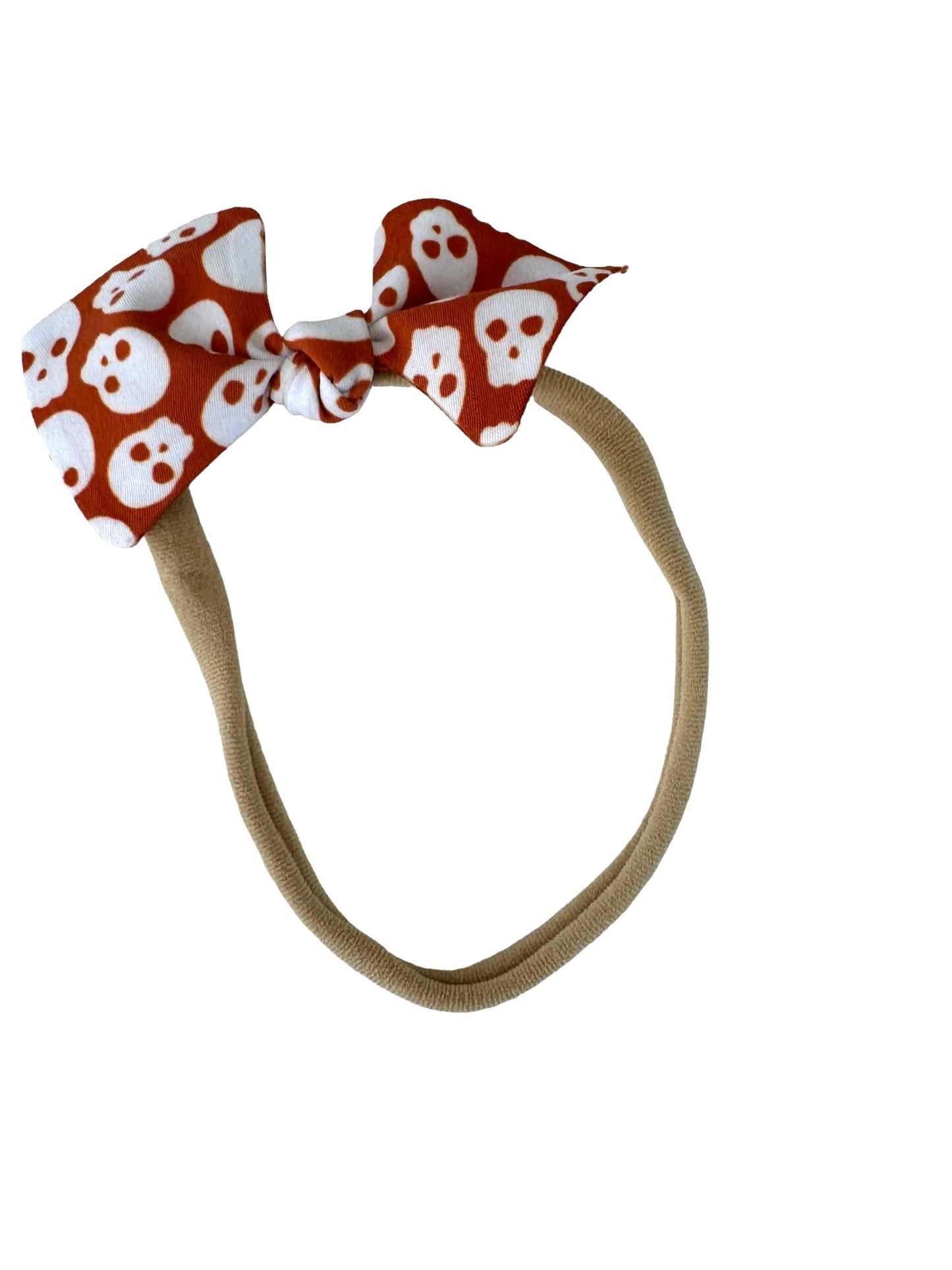 orange and white skulls on a nylon headband for babies