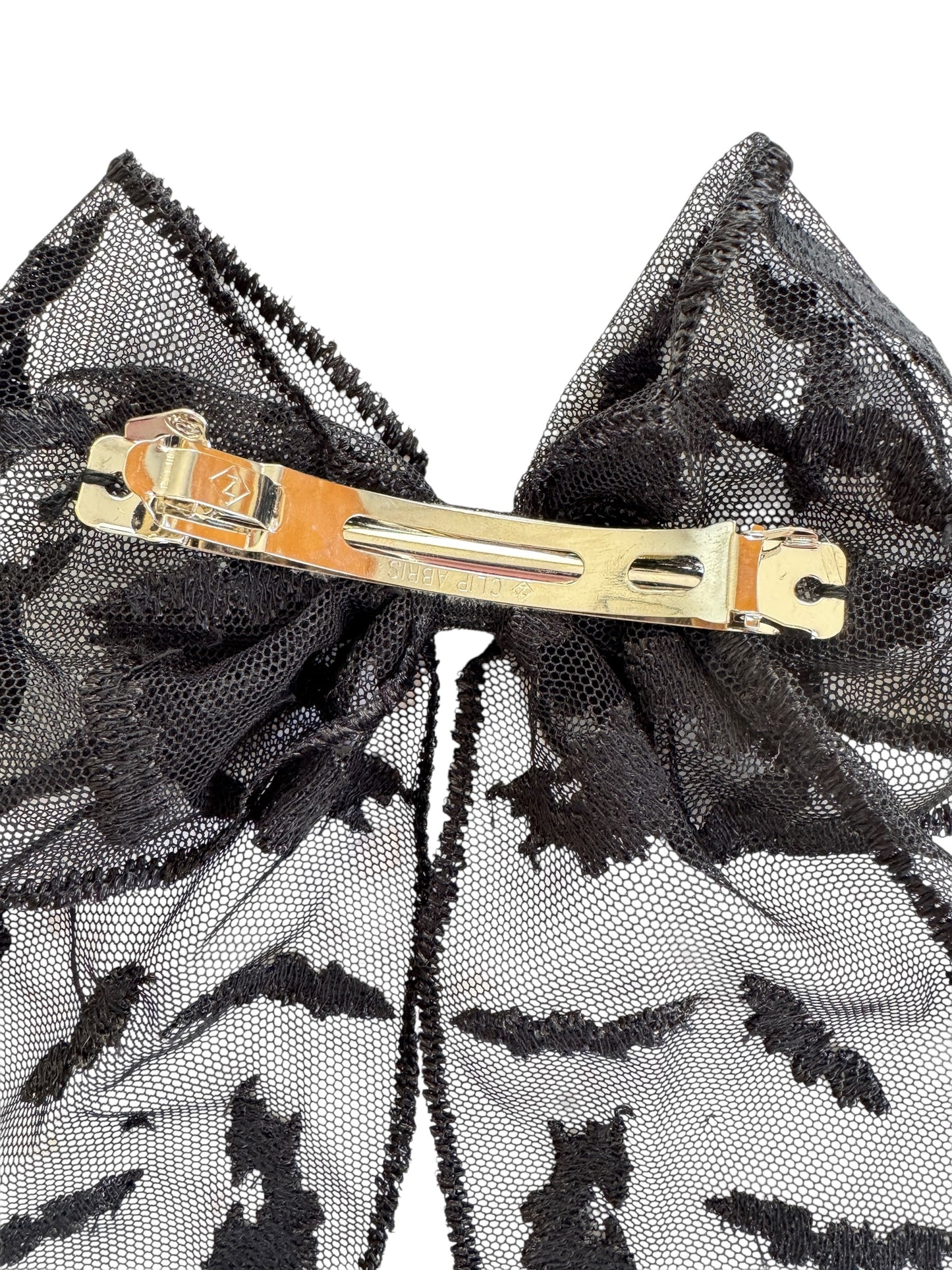 Black lace hair bow with a barrette on a white background