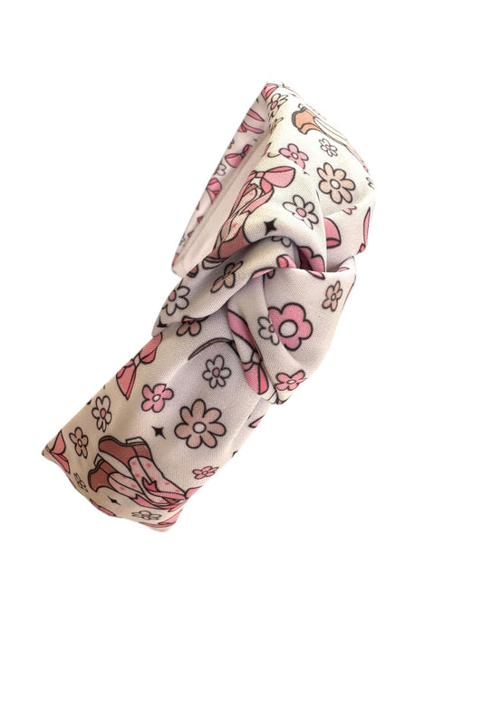 headband with a pattern of boots and bows in pink and brown colors on a white background
