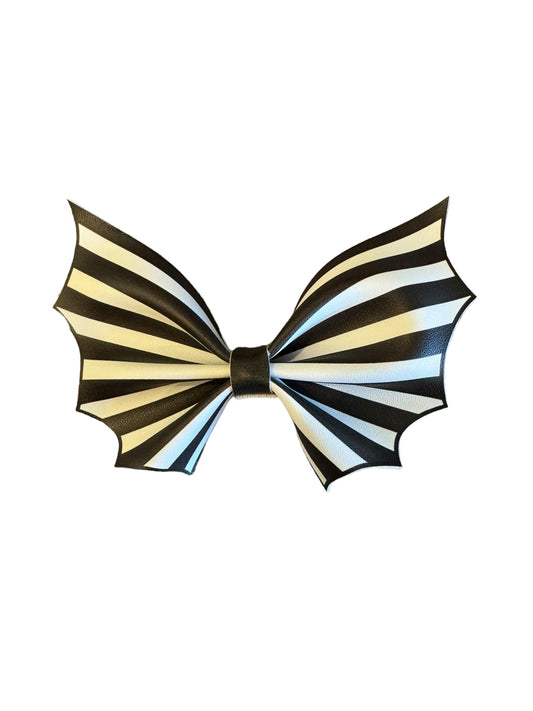 black and white striped bat-shaped faux leather hair bows with alligator clips attached.