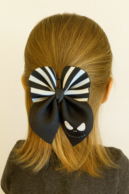 little girl wearing a jack skeleton bow