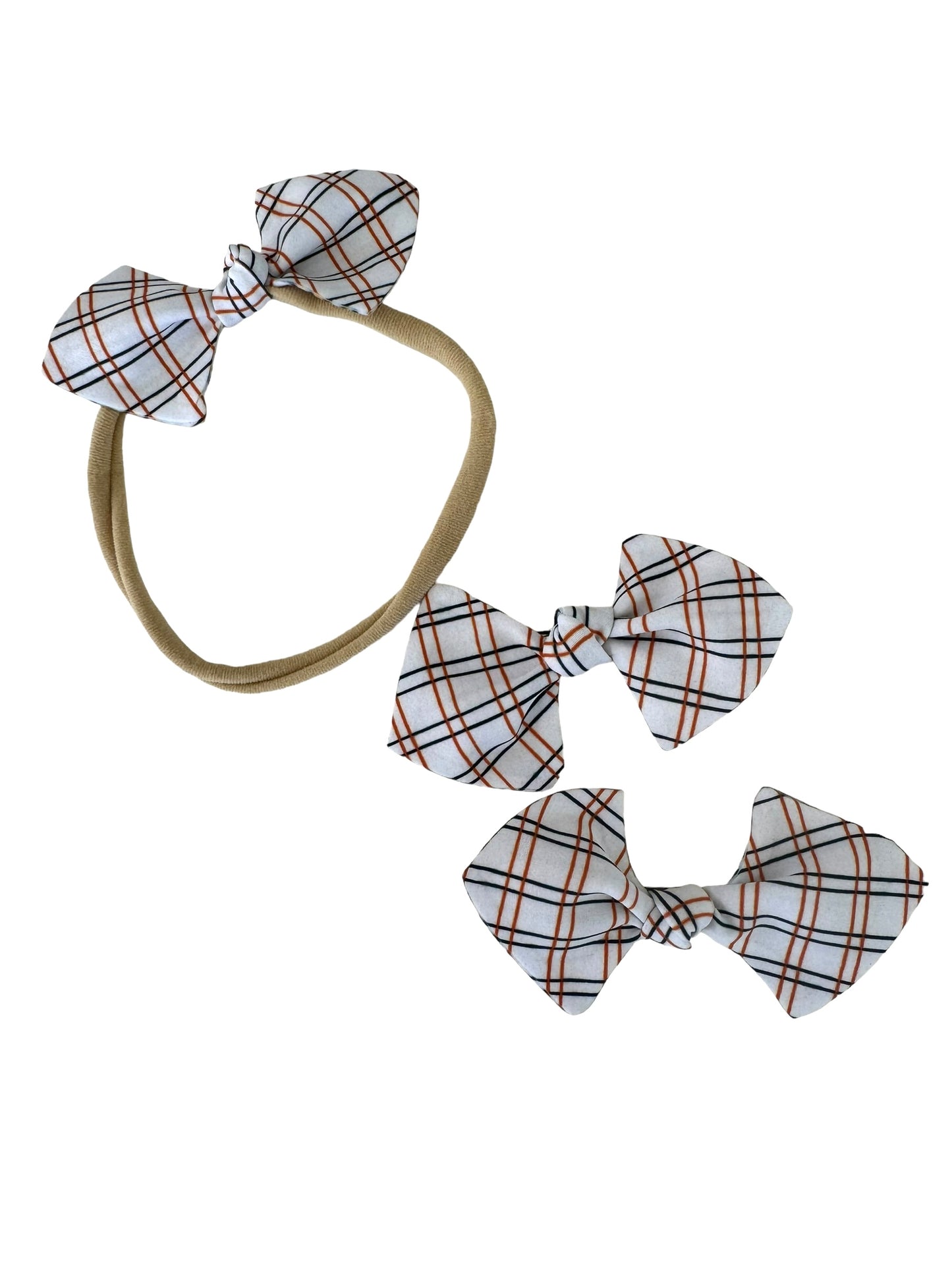 orange and black plaid mini bows on an alligator clip and a nylon headband for babies
