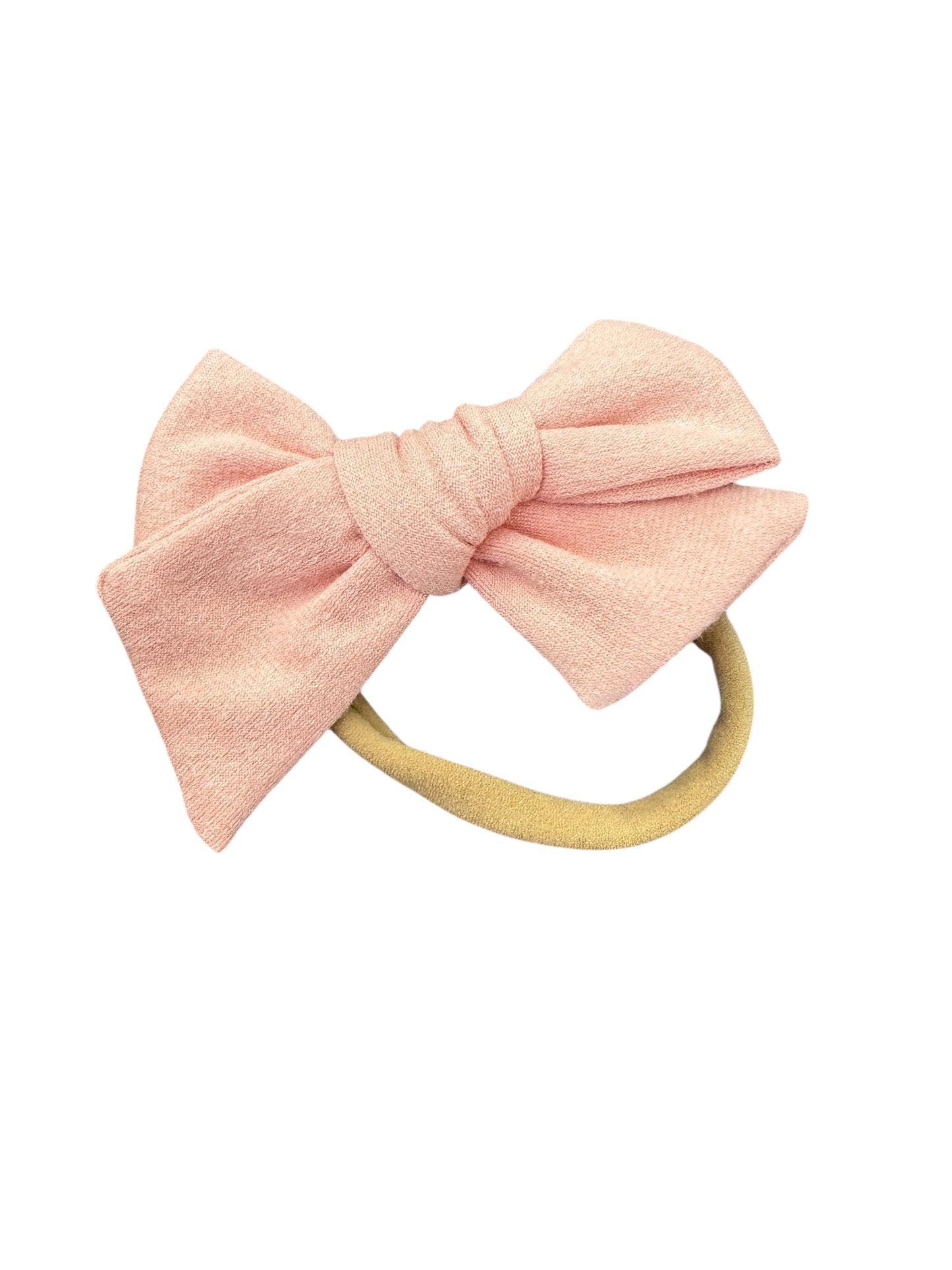 Pink bow hair accessory on a white background