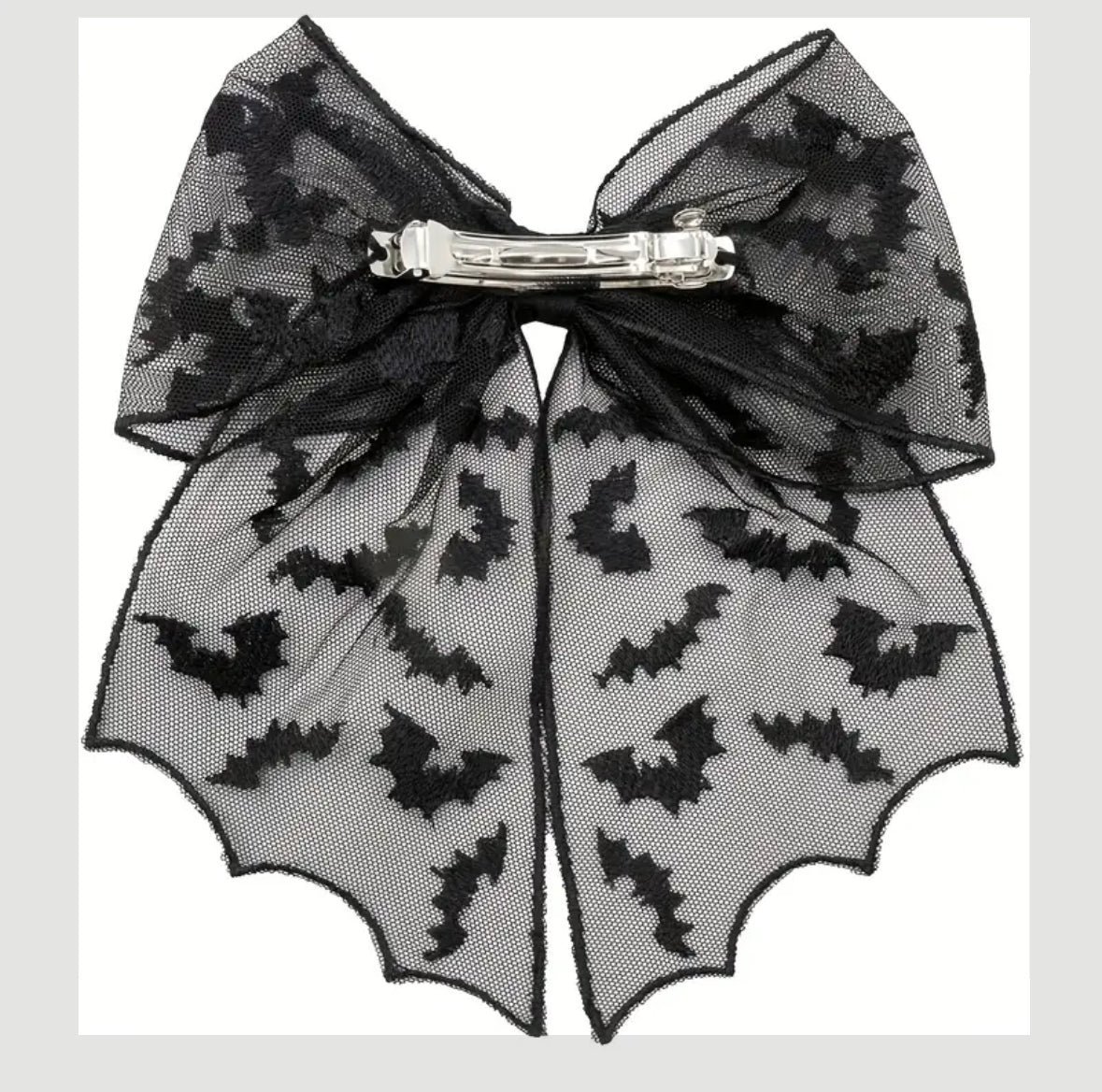 Black bat patterned bow hair clip on a white background