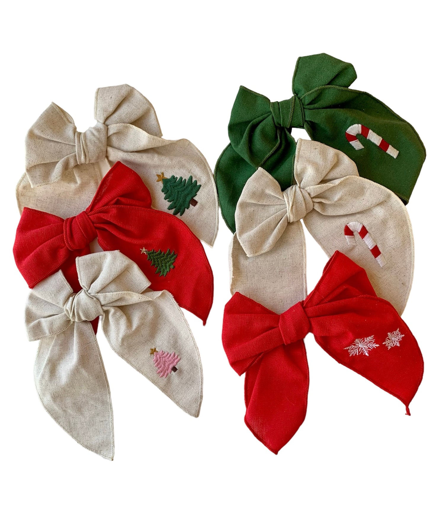 A set of Red and beige linen hair bow with a Christmas tree embroidery on it, attached to an alligator clip.