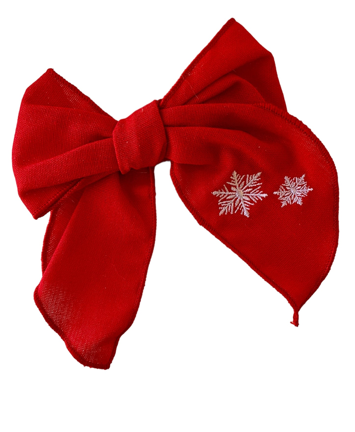 A red linen hair bow with a snowflake embroidery on it, attached to an alligator clip.