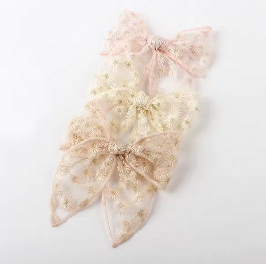 hair bow with floral lace details on a white background