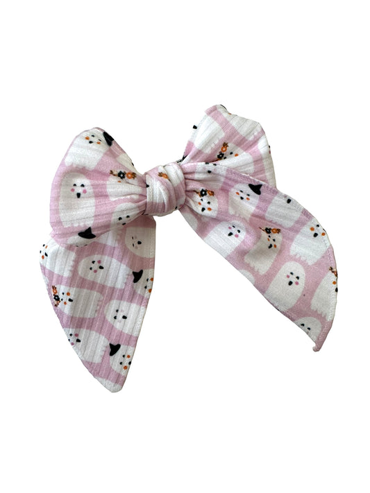 A set of pink ghost hair bows in various styles including an alligator clip, nylon headband, and tie knot headband, displayed on white cards.