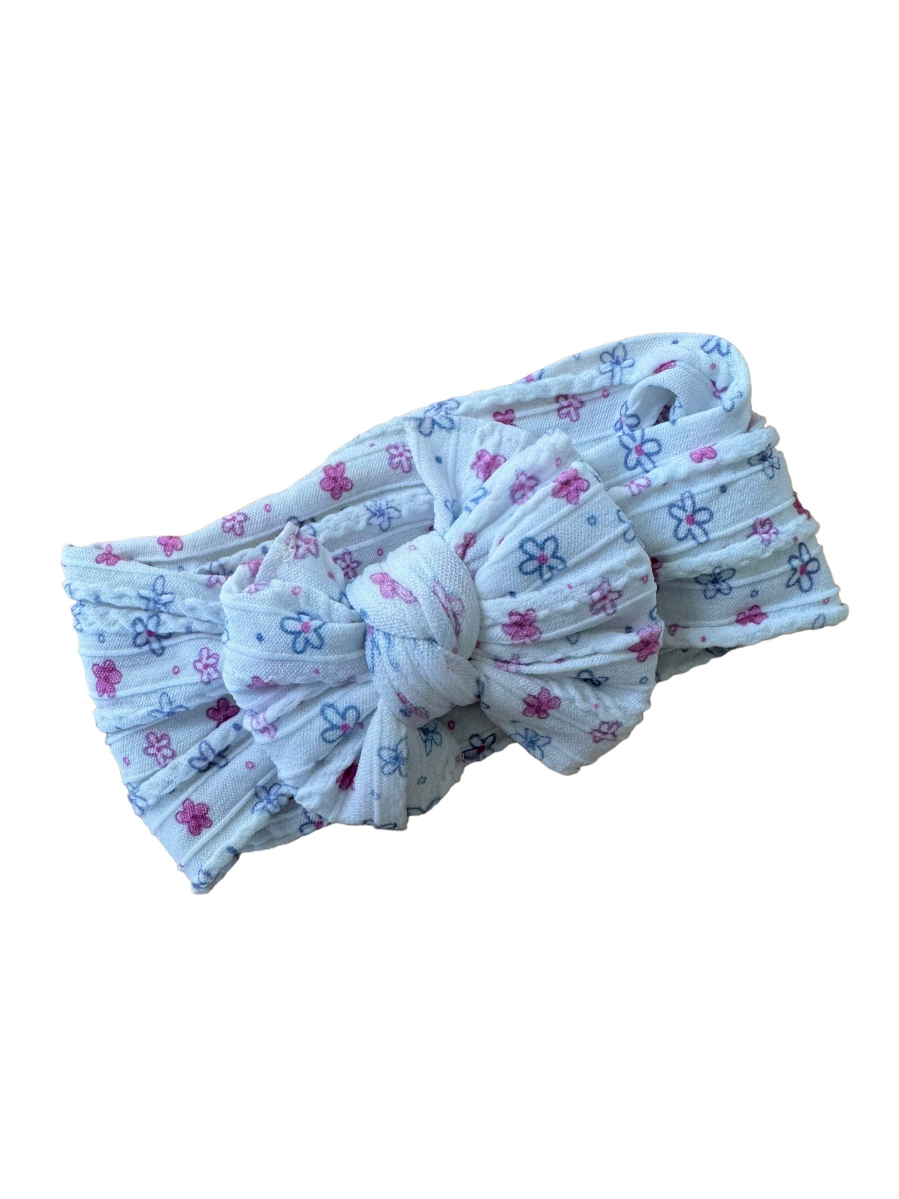A flower patterned nylon headwraps for babies with large bow