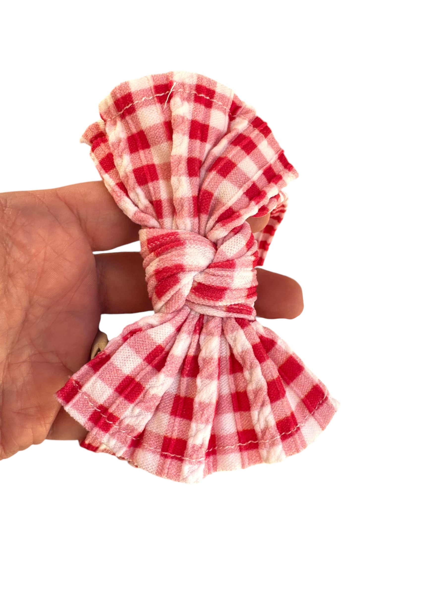 A red plaid patterned infant headband for babies with large bow