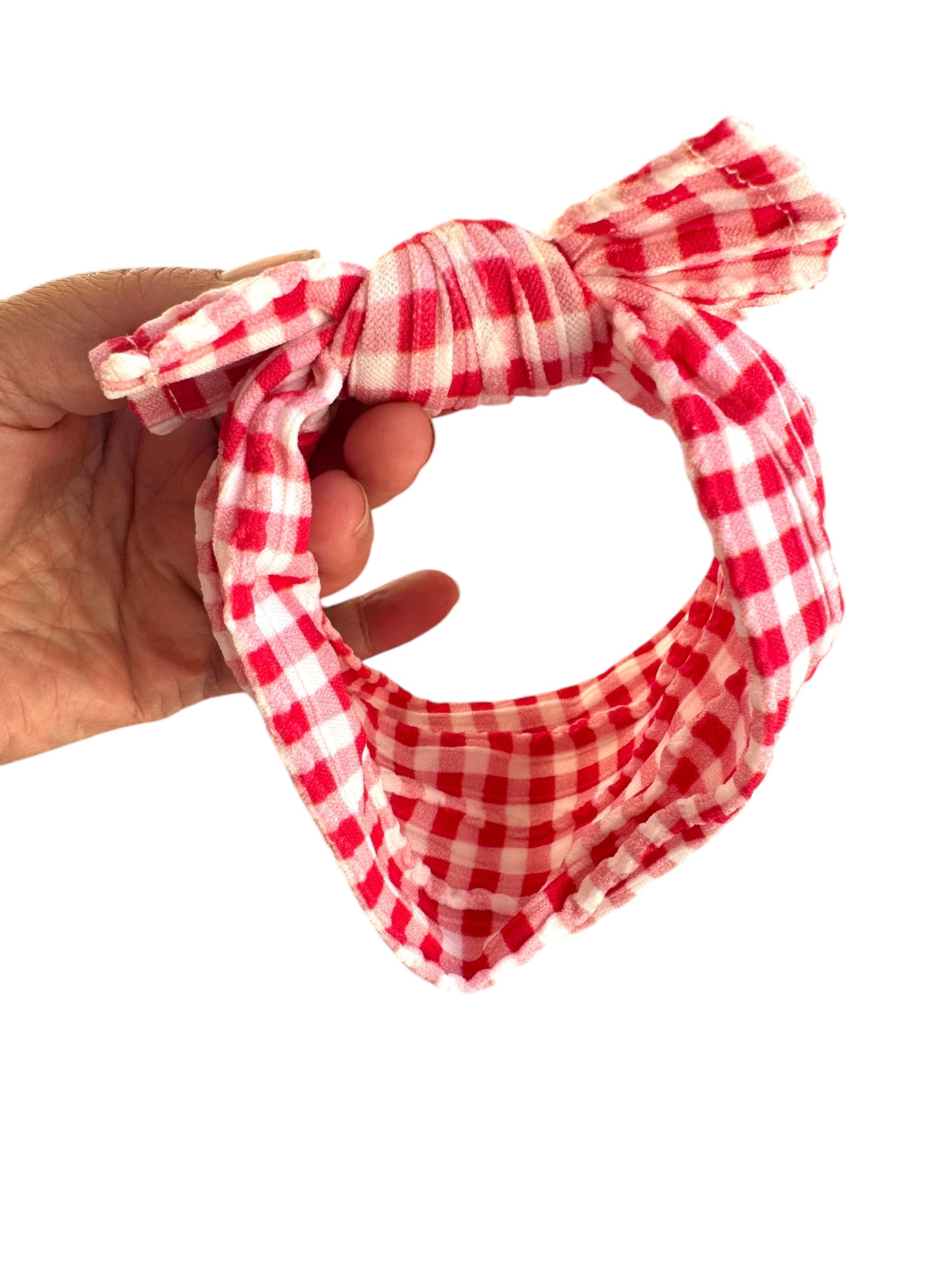 A red plaid patterned infant headband for babies with large bow