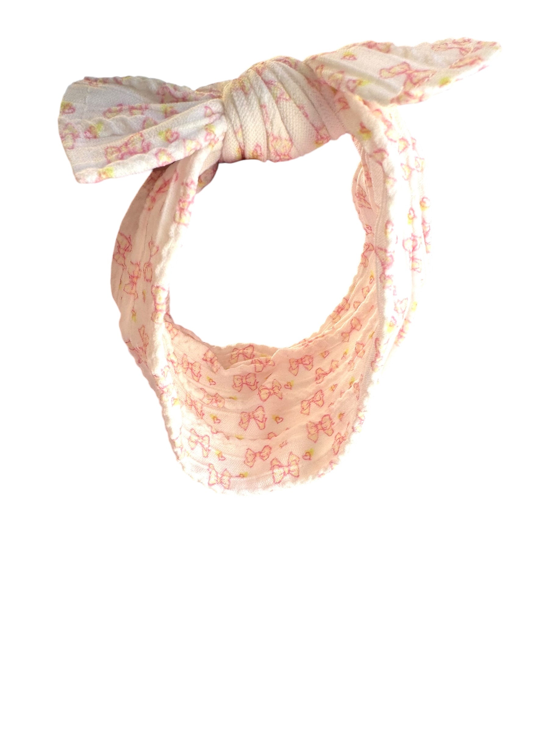 A pink bow patterned nylon headband for babies with large bow