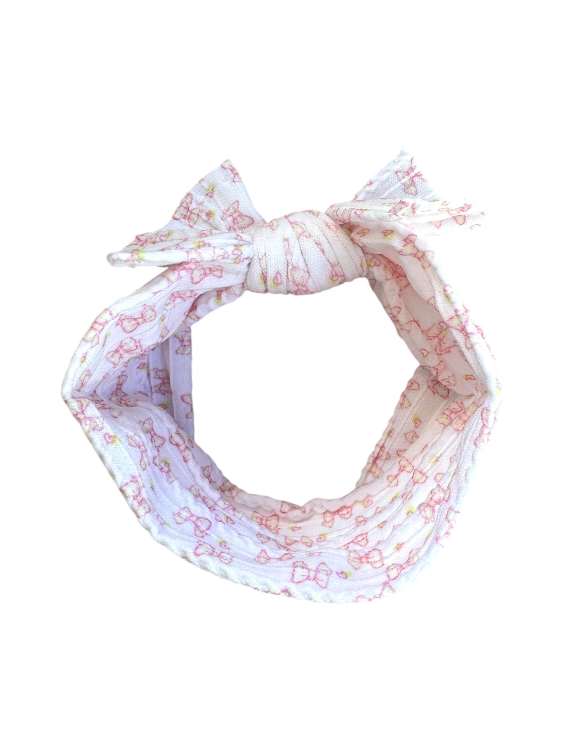 A pink bow patterned nylon headband for babies with large bow