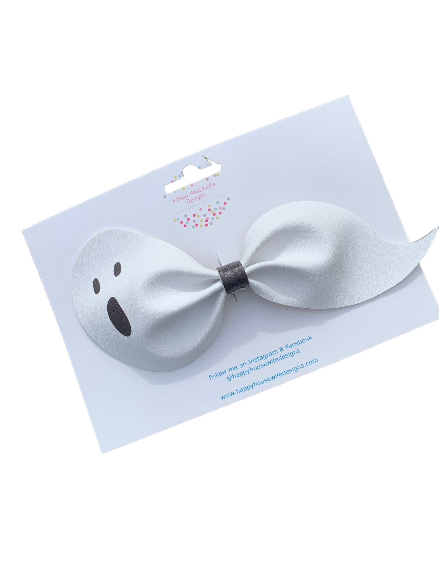 A set of faux leather hair bows in various colors with an alligator clip attached, displayed on a card.