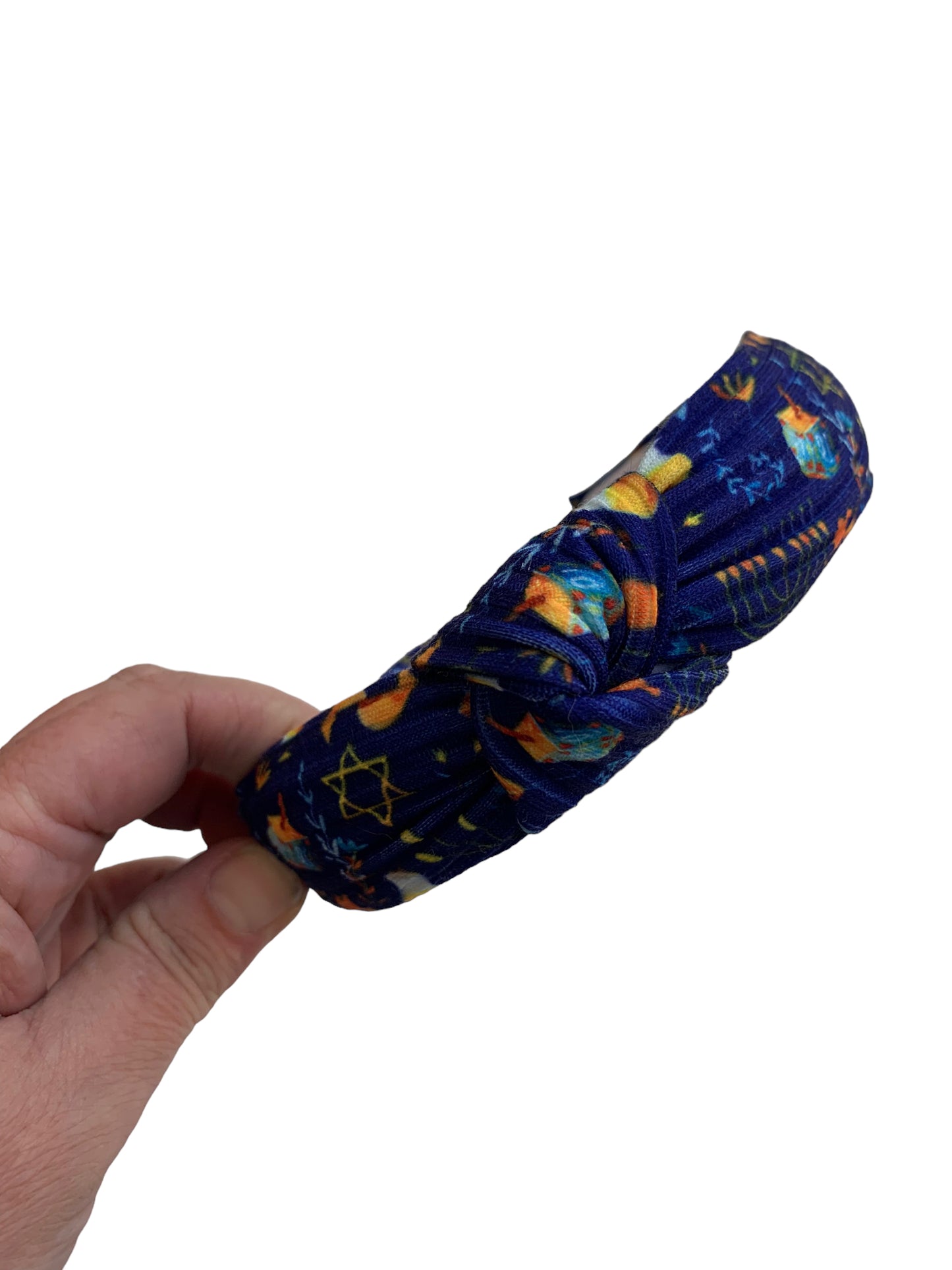 A headband with patterned designs including stars and menorahs.