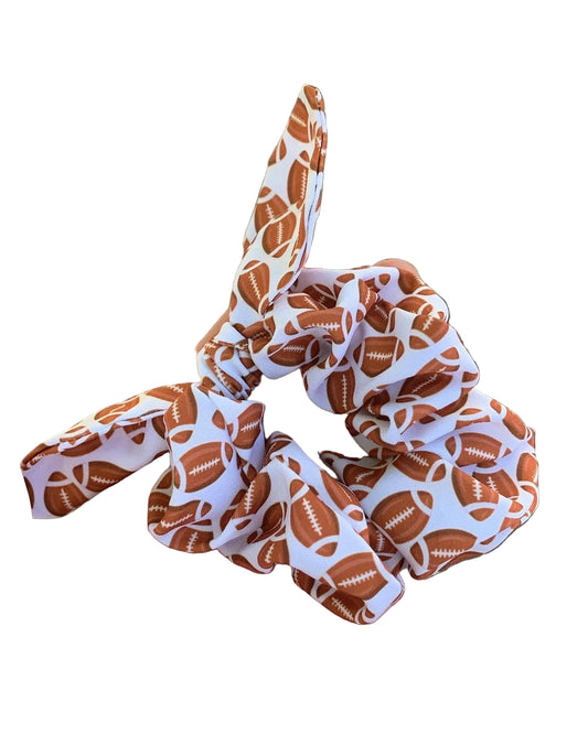 a brown and white scrunchie with footballs