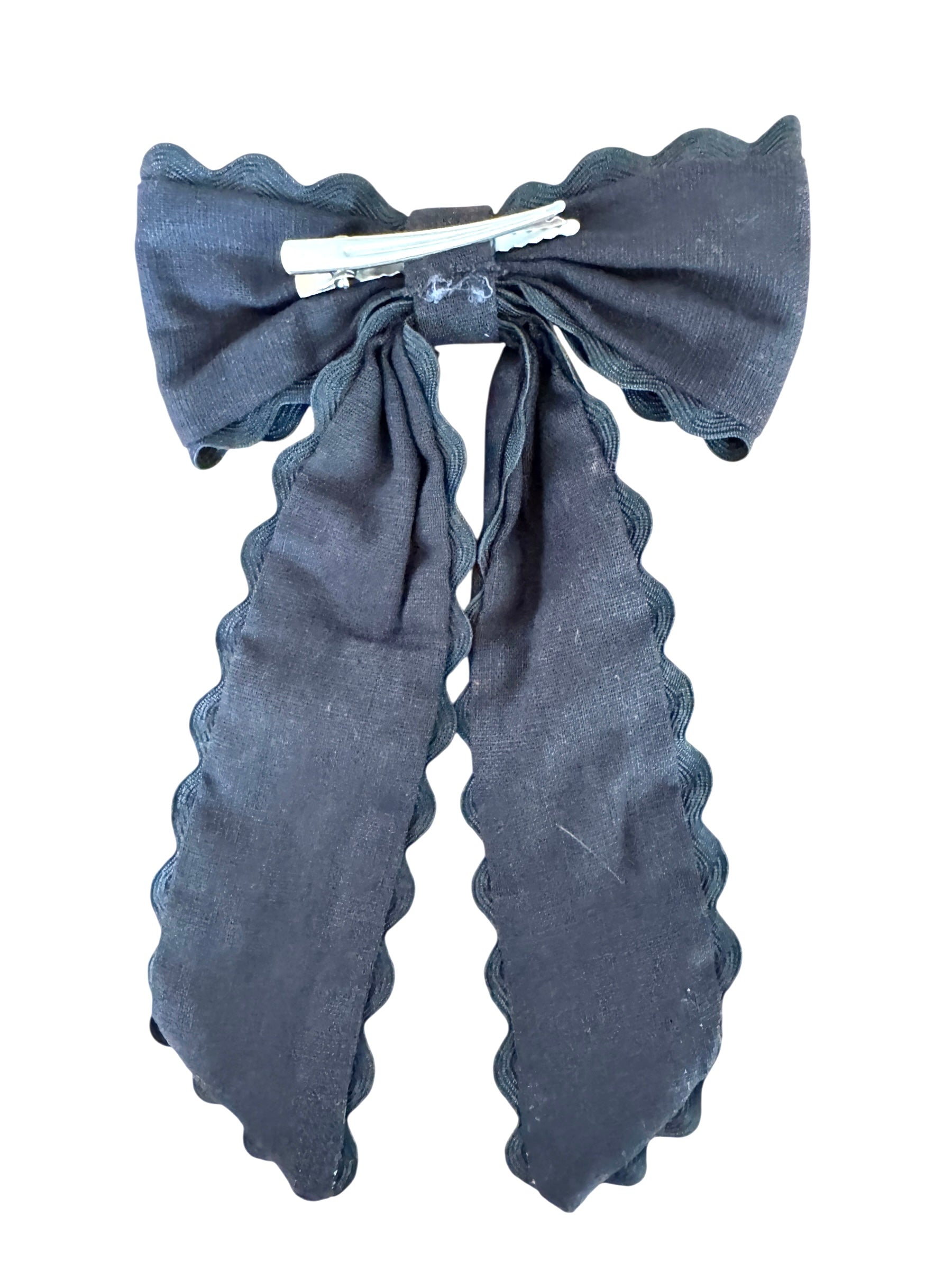 Black hair bow with ruffled edges on a white background