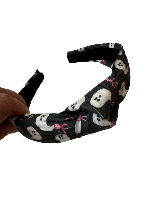 Packaged hair bows with black ghost patterns and pink bows, displayed on a white background.