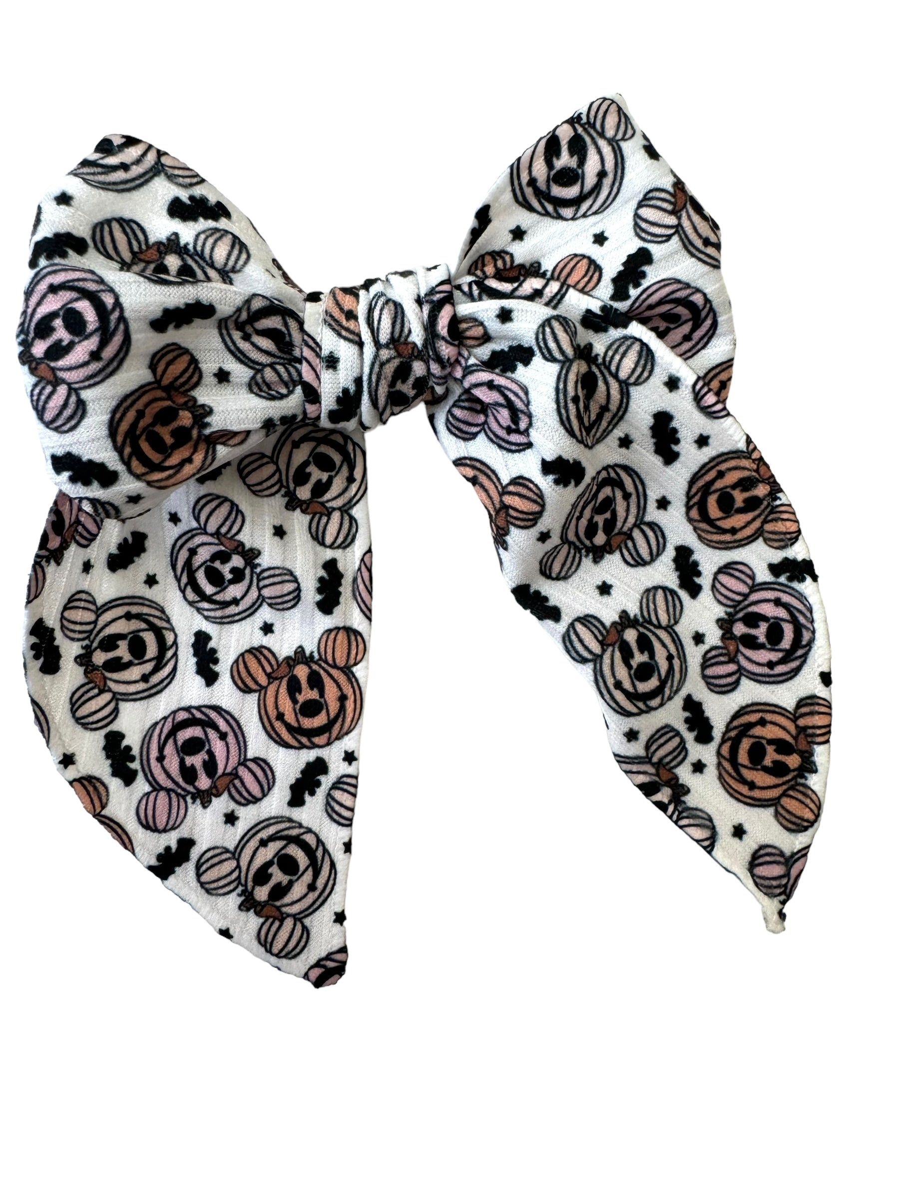 A set of hair bows with a pumpkin and mouse pattern displayed on alligator clips