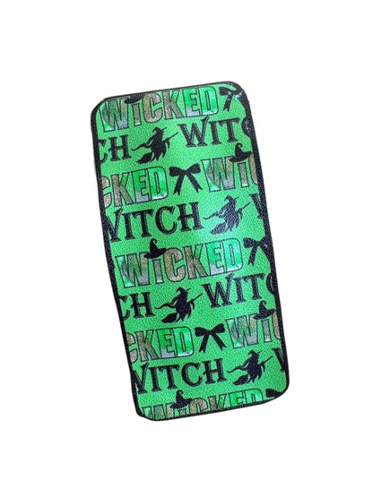 Green snap clip with 'Wicked Witch' text and silhouettes on a white background