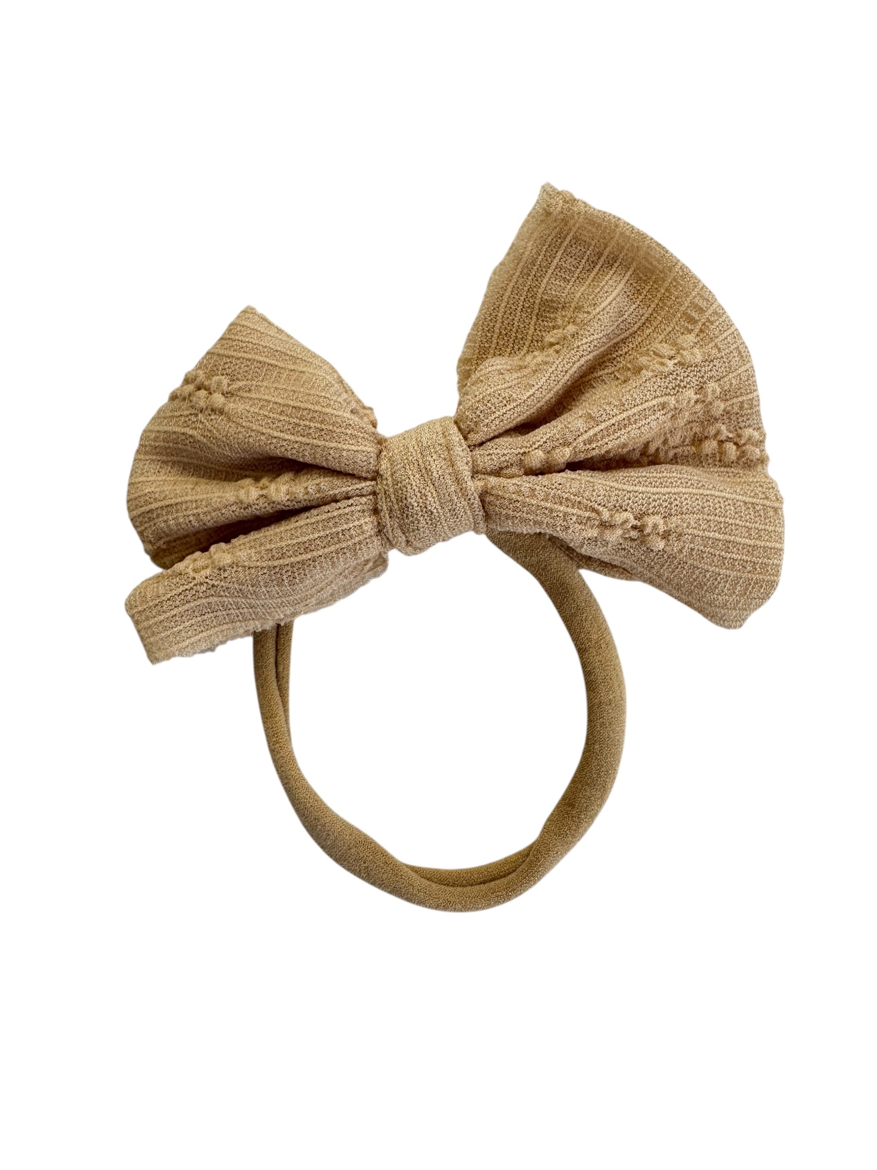 Tan bow headband on a white background