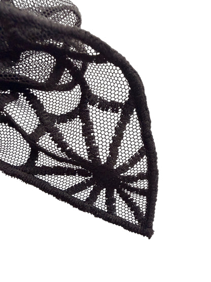 Black lace fabric with a detailed spiderweb pattern, shown draped against a solid white background.