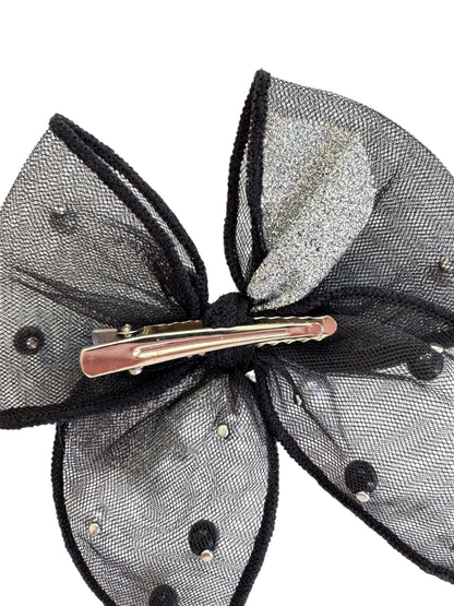 Black and silver hair bow with a clip on a white background
