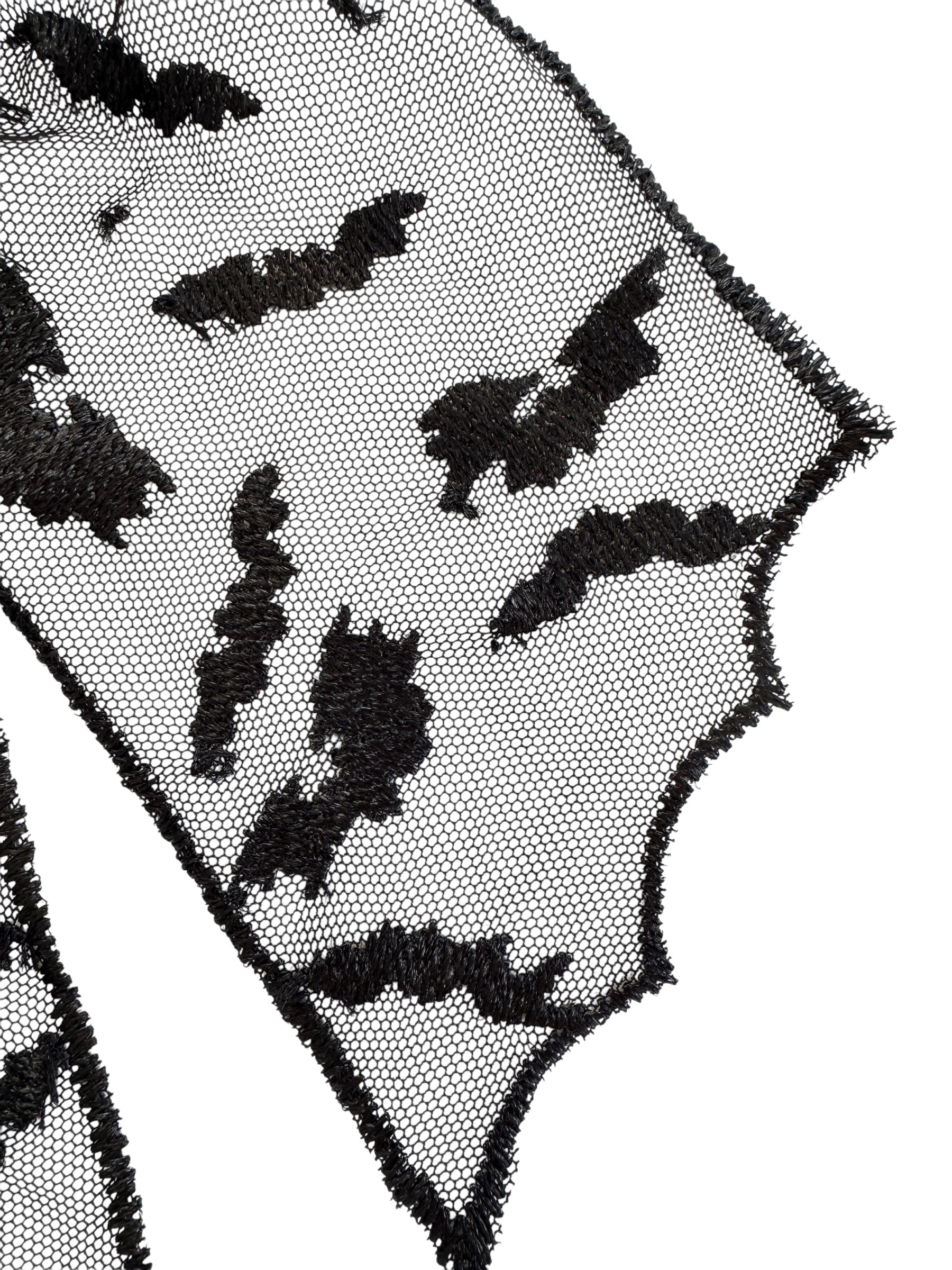 Black bat patterns on a sheer black fabric background