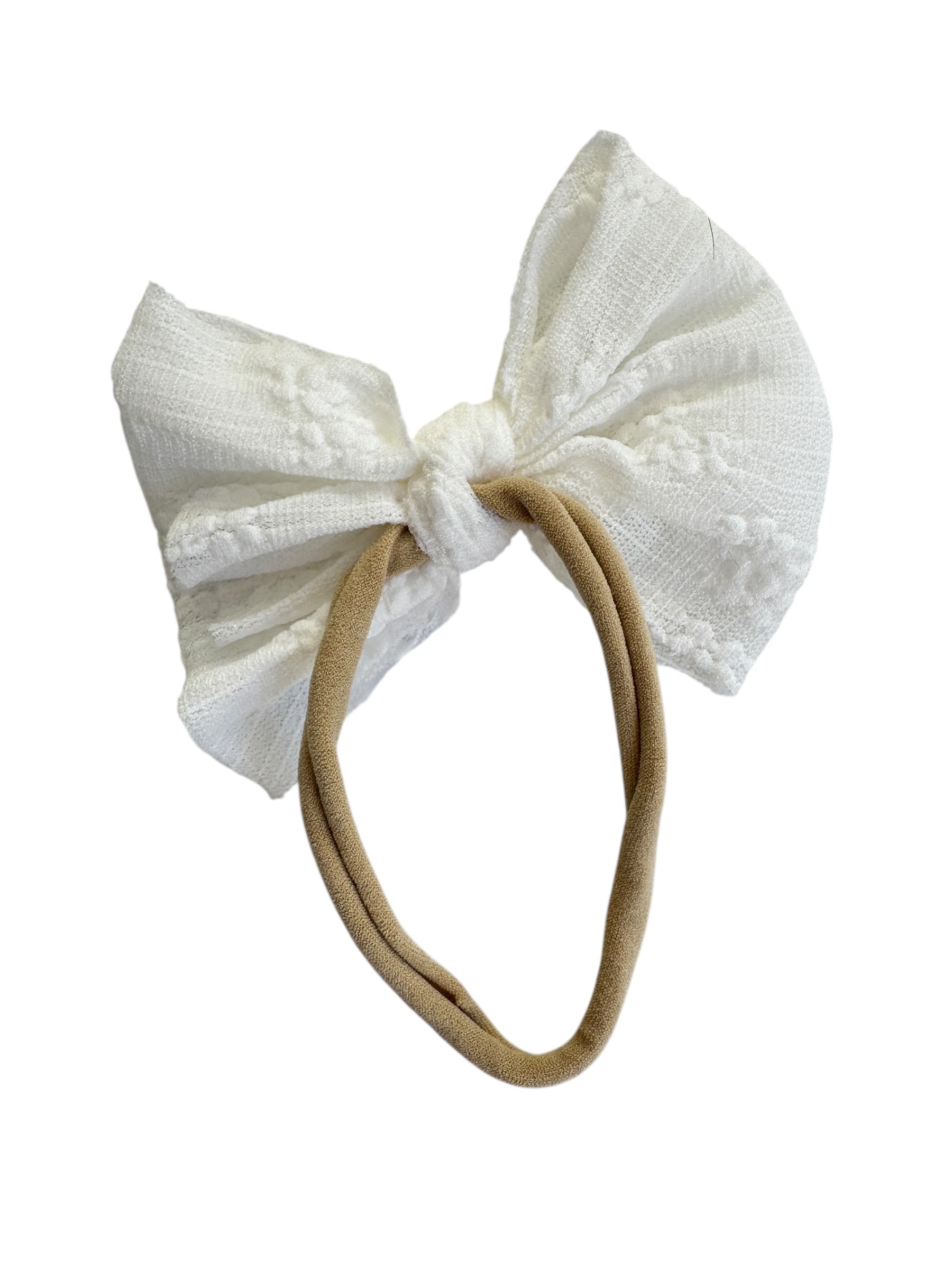 White textured bow headband on a beige band against a white background