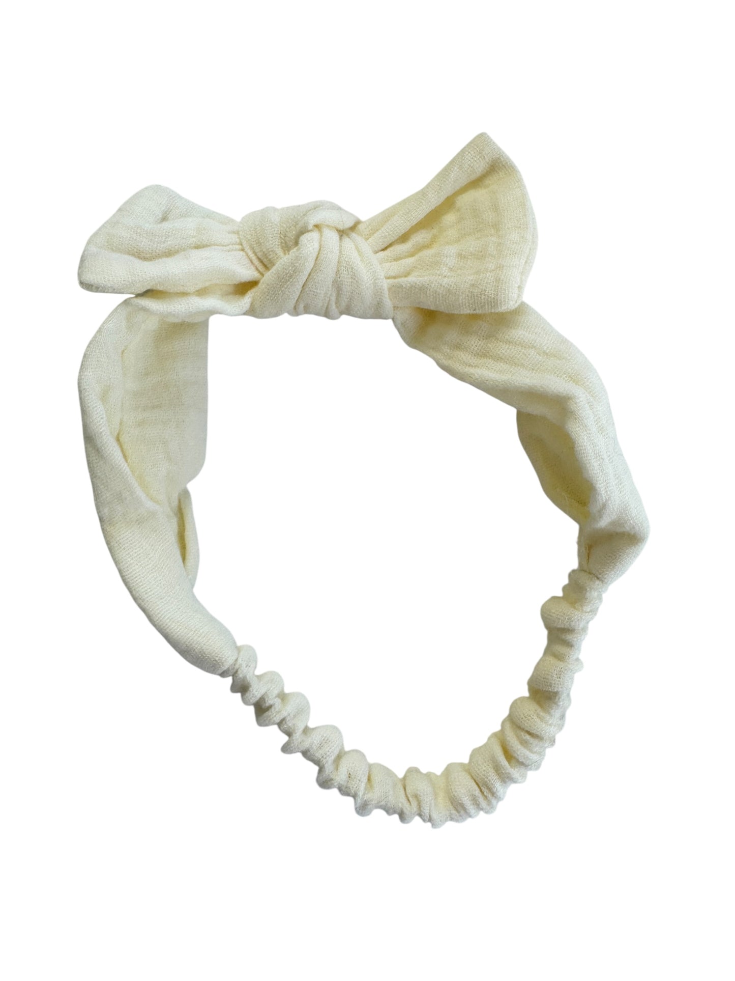 Cream-colored headband with a knotted design on a white background