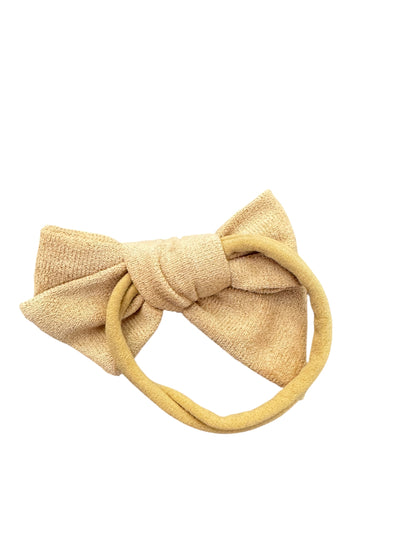 Beige knotted headband on a white background