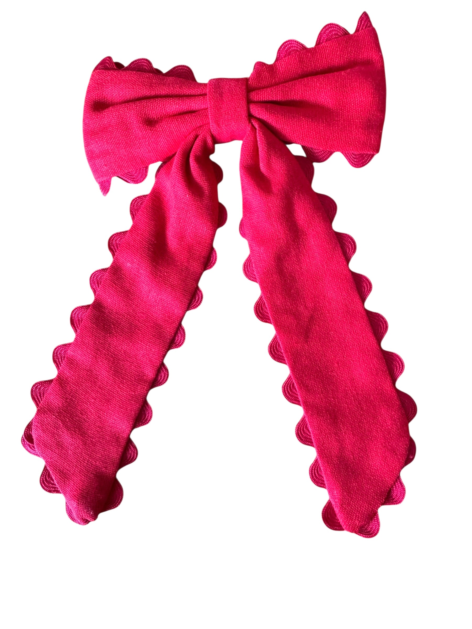 Red bow with ruffled edges on a white background