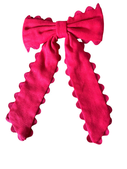 Red bow with ruffled edges on a white background