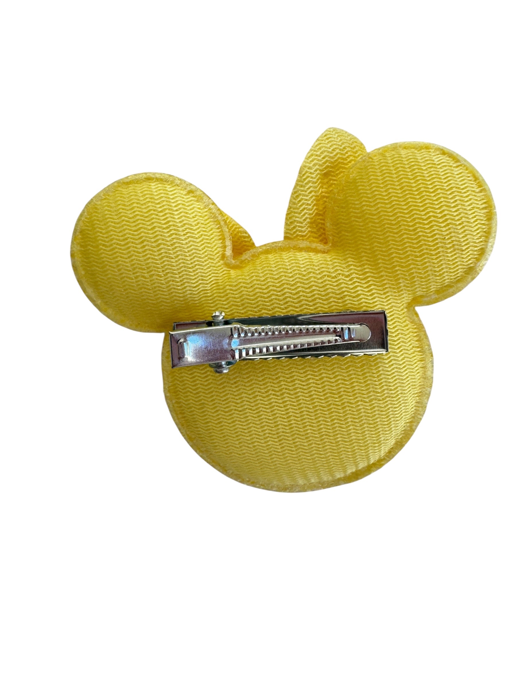 Yellow hair clip shaped like a mouse ear on a white background
