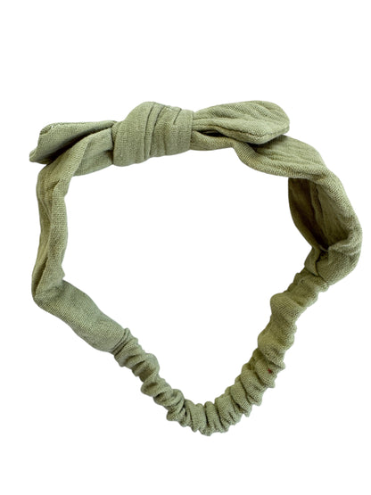 Green headband with a knot on a white background