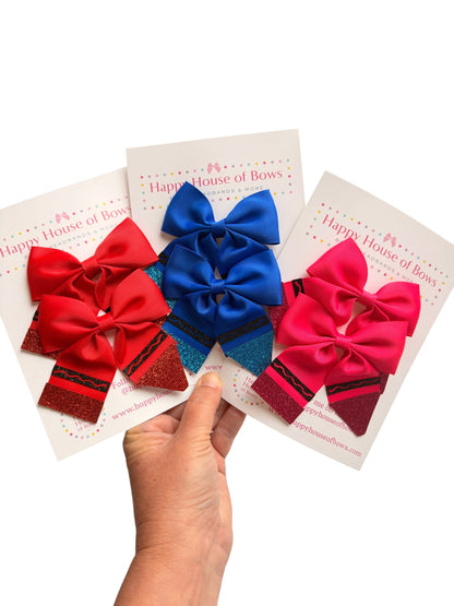 Three decorative hair bows in red, blue, and pink are displayed on white backing cards held by a hand against a white background. The cards are branded Happy House of Bow.