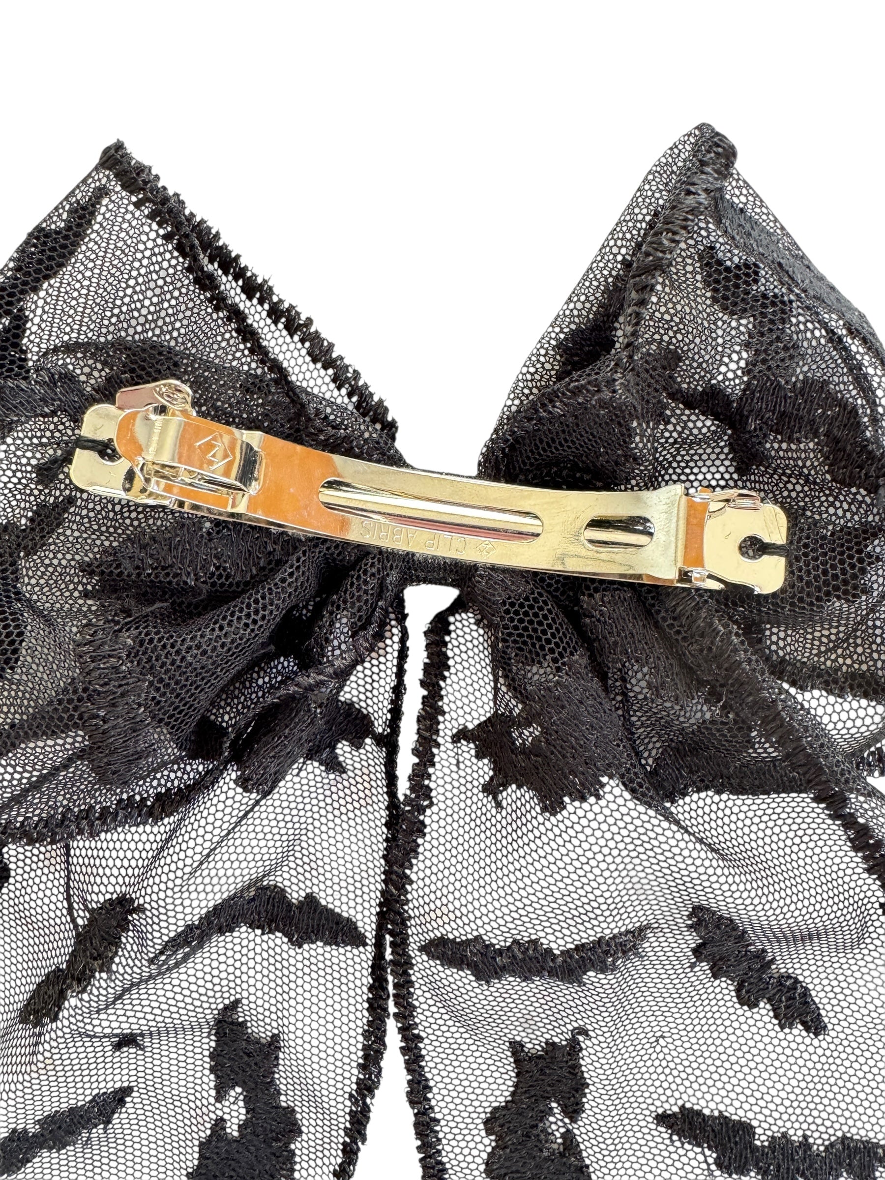 Black lace hair bow with a barrette on a white background