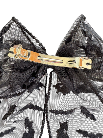 Black lace hair bow with a barrette on a white background