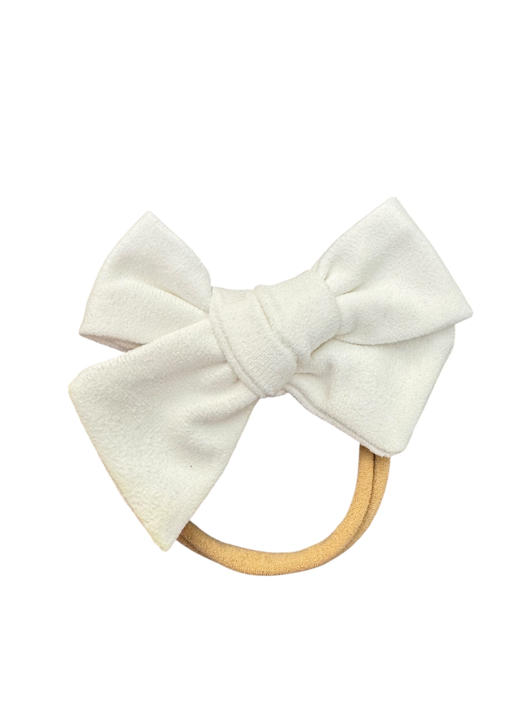 White bow hair accessory with wooden ring on a white background