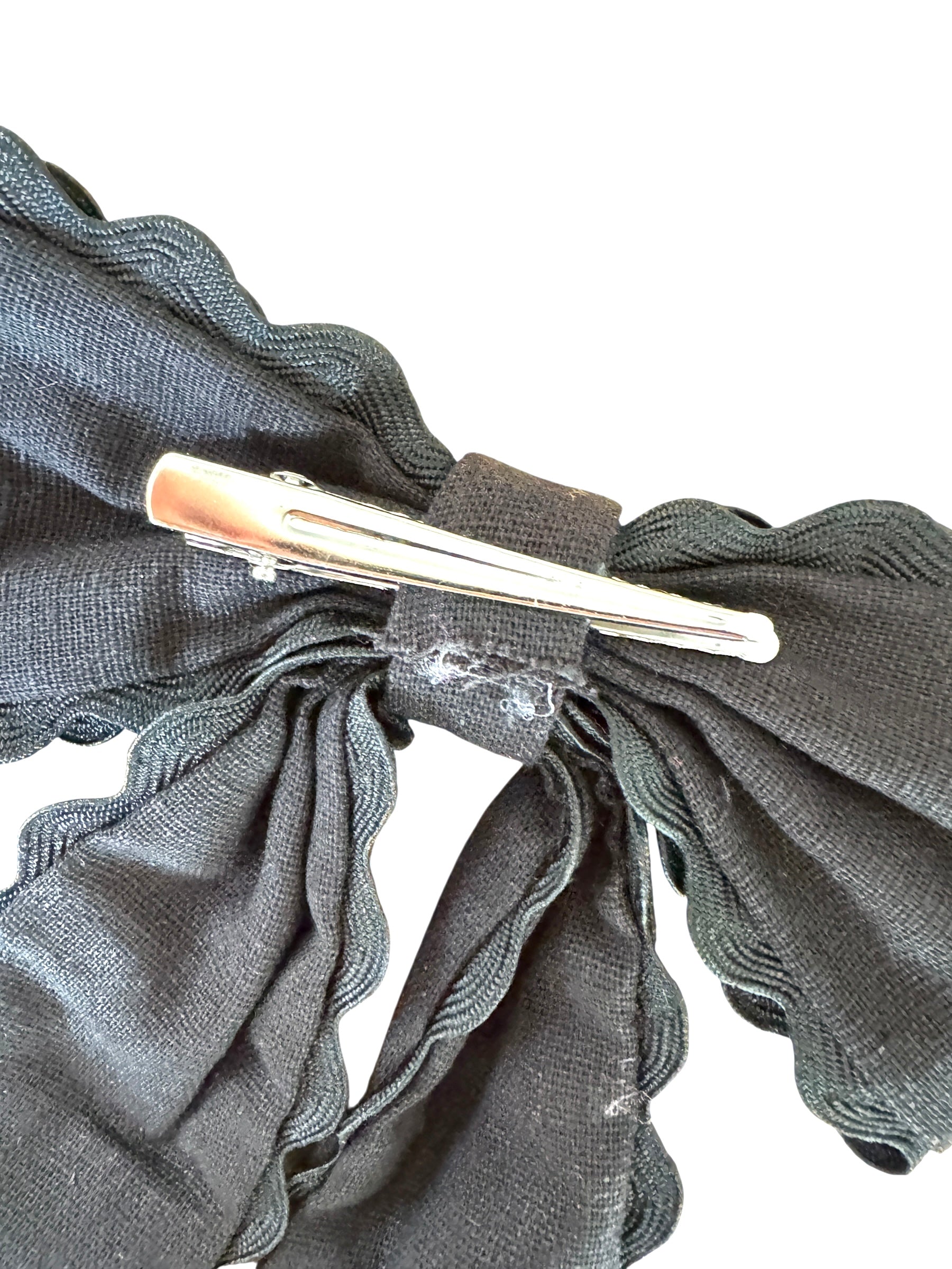 Silver hair clip on a gray fabric background