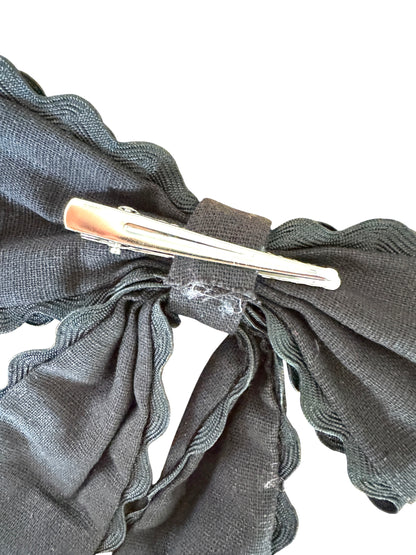 Silver hair clip on a gray fabric background