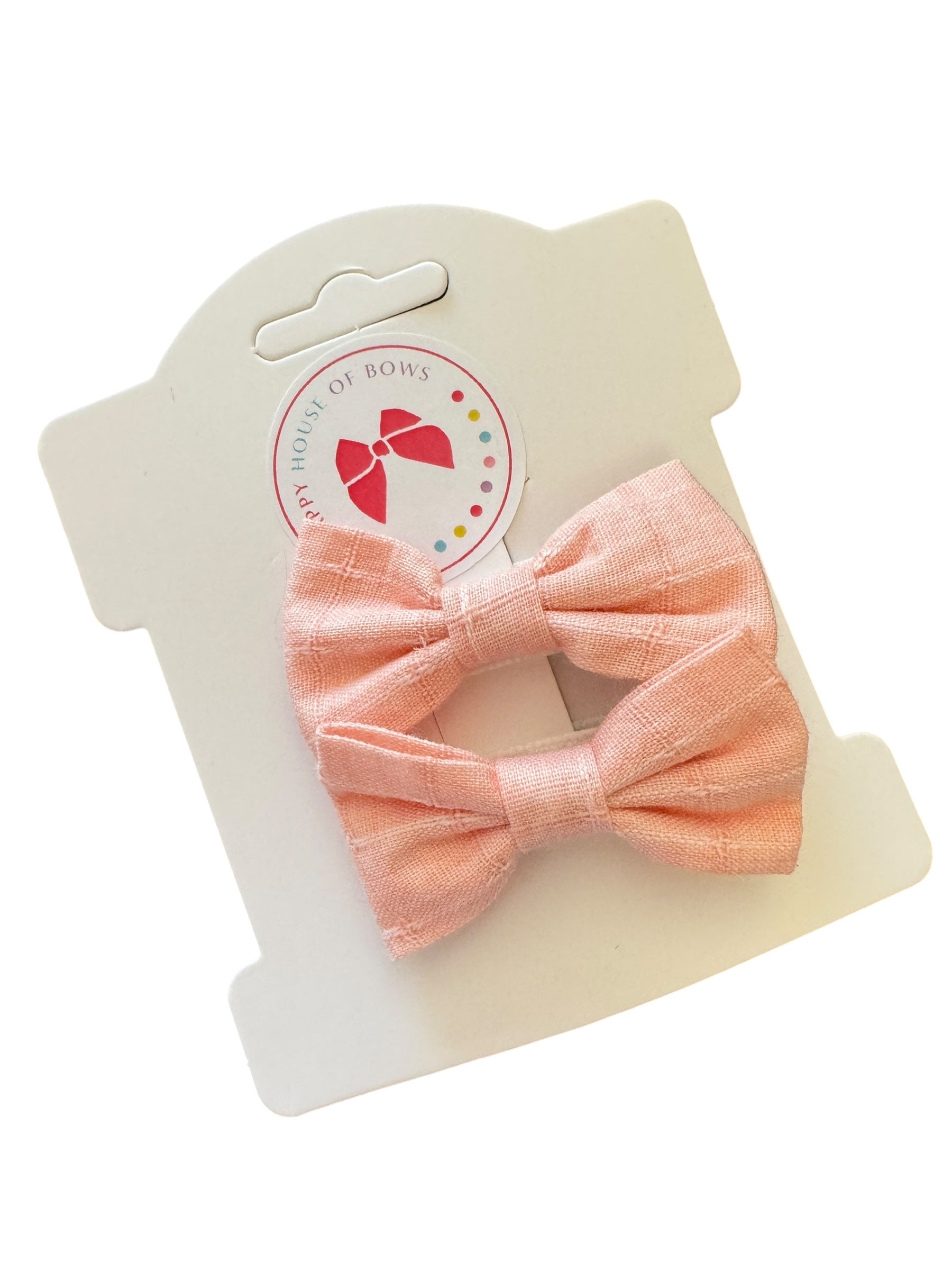 Pink bow on a white card with a brand logo