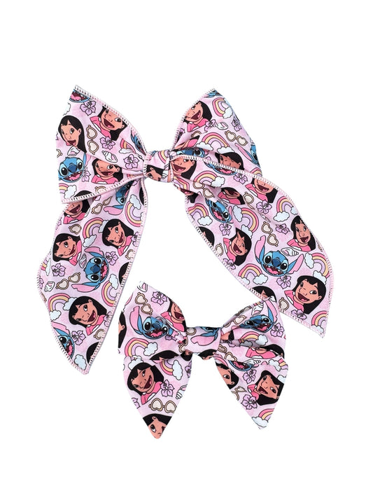 Two hair bows with cartoon character design on a white background